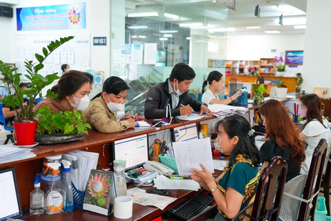 Mất việc tuổi 50: Chẳng lẽ nghẹn ngào rồi bó tay- Ảnh 2. Chuyên viên BHXH TP.HCM làm thủ tục BHXH cho người dân - Ảnh: HỮU HẠNH