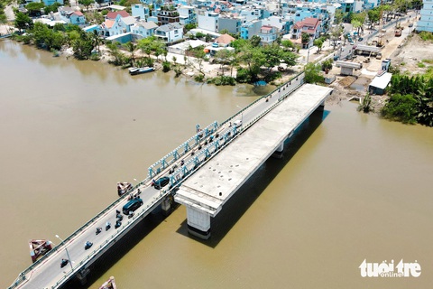 Dự kiến tháng 12 năm nay người dân Nhà Bè, quận 7 sẽ qua lại trên cầu Phước Long, Rạch Đỉa- Ảnh 1. Một đoạn cầu Phước Long đã thành hình, nằm song song với cầu cũ bắc qua rạch Đỉa. Dự án xây dựng cầu Phước Long mới (bên phải) bắc qua rạch Phú Xuân (nối quận 7 và huyện Nhà Bè, TP.HCM) được thực hiện bằng vốn ngân sách nhà nước - Ảnh: PHƯƠNG NHI
