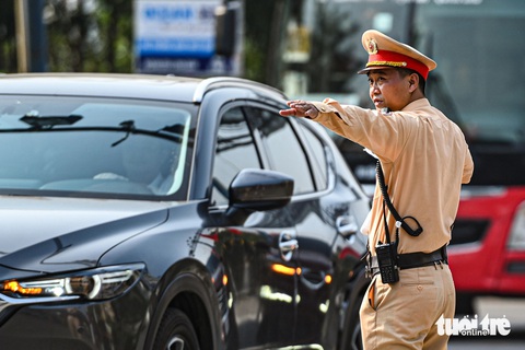 Người dân đội nắng rời Hà Nội về nghỉ lễ, càng về tối càng ùn tắc- Ảnh 5. Cán bộ đội cảnh sát giao thông số 14 được huy động, ứng trực liên tục để đảm bảo phân luồng - Ảnh: HỒNG QUANG