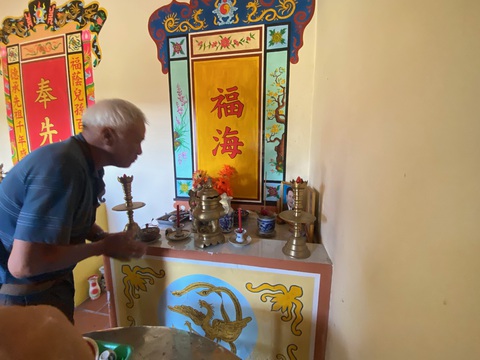 Xóm Mồ Côi chỉ 7 nóc nhà nhưng có 10 liệt sĩ, 2 anh hùng- Ảnh 3. Ông Sơn sửa soạn bàn thờ - Ảnh: B.D.