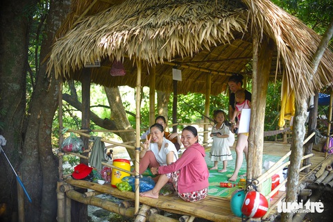 Trên bờ suối, nhiều du khách thích thú ngắm cảnh bên những chòi lá mộc mạc - Ảnh: LÂM THIÊN Trên bờ suối, nhiều du khách thích thú ngắm cảnh bên những chòi lá mộc mạc - Ảnh: LÂM THIÊN