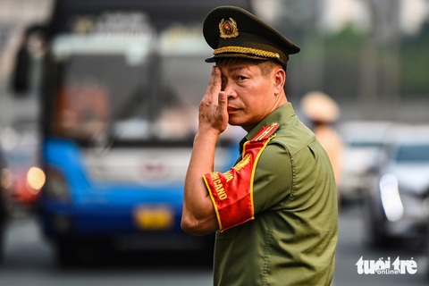 Chưa hết nghỉ lễ, người dân ùn ùn trở lại Hà Nội trong nắng nóng 41 độ C- Ảnh 5. Lực lượng công an địa phương tăng cường hỗ trợ cảnh sát giao thông phân luồng trên cao tốc do lượng xe tăng vọt. Hoạt động lâu ngoài trời cùng hơi nóng nhựa đường khiến họ mướt mải mồ hôi - Ảnh: HỒNG QUANG