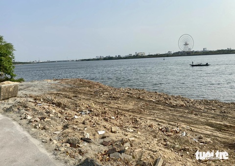Xà bần đổ lấn sông Hàn gần cầu Trần Thị Lý Đà Nẵng- Ảnh 3. Nhiều điểm đất đá tràn ra khỏi bờ kè rộng hơn 4m - Ảnh: TRƯỜNG TRUNG