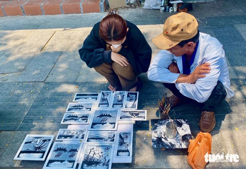 Họa sĩ rong và những bức tranh sơn dầu hoài cổ Nha Trang- Ảnh 6. Du khách dừng lại xem tranh của người họa sĩ đường phố