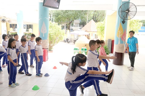 Cao điểm nắng nóng, các trường lo cho học sinh ra sao?- Ảnh 1. Học sinh Trường tiểu học Nguyễn Bỉnh khiêm (quận 1, TP.HCM) học thể dục dưới sảnh tòa nhà của trường để tránh nắng nóng - Ảnh: NGỌC PHƯỢNG