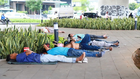 Trốn nóng dưới 'khách sạn' gầm cầu, bóng cây- Ảnh 1. Nhiều công nhân không có võng, nằm luôn dưới dạ cầu Ba Son để nghỉ trưa - Ảnh: AN VI