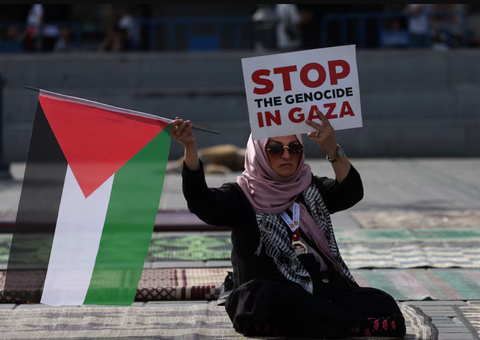 Thổ Nhĩ Kỳ hạn chế xuất khẩu đến Israel cho đến khi có lệnh ngừng bắn- Ảnh 1. Một người phụ nữ cầm cờ Palestine và biểu ngữ với nội dung ủng hộ người Palestine ở Gaza tại thành phố Istanbul, Thổ Nhĩ Kỳ vào tháng 10-2023 - Ảnh: REUTERS