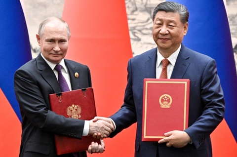 Các hoạt động chính trong chuyến thăm Trung Quốc của ông Putin- Ảnh 3. Chủ tịch Trung Quốc Tập Cận Bình (phải) và Tổng thống Nga Vladimir Putin trao đổi văn kiện hợp tác trong lễ ký tuyên bố chung tại Bắc Kinh, ngày 16-5 - Ảnh: AFP
