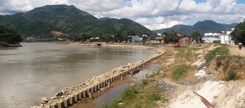 Vì sao đề xuất cắt bớt kè sông Cái Nha Trang nhưng vốn đầu tư lại tăng?- Ảnh 1. Khu vực bờ hữu sông Cái Nha Trang (tại xã Vĩnh Ngọc, TP Nha Trang) đã được đầu tư, tiến hành xây dựng kè, đường bờ hữu ven sông - Ảnh: PHAN SÔNG NGÂN