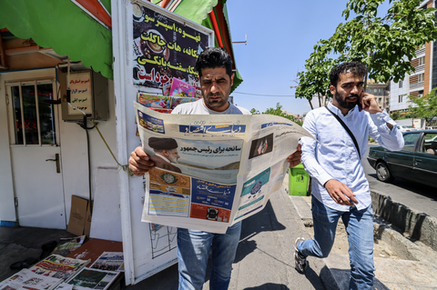 Tổng thống tử nạn, chờ xem lãnh đạo tối cao dẫn dắt Iran- Ảnh 3. Người dân Iran đọc báo với trang bìa nói về cái chết của ông Raisi - Ảnh: REUTERS