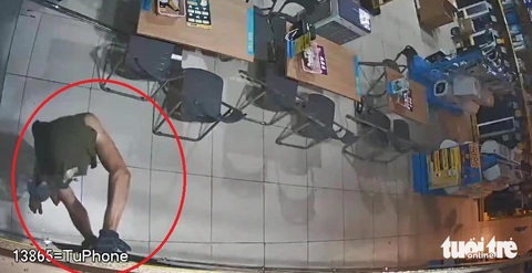 Cởi áo để trùm đầu rồi trèo vào cửa hàng Điện Máy Xanh trộm 8 điện thoại- Ảnh 1. Dực đột nhập cửa hàng bằng đường trên mái nhà, rồi mở tủ lấy 8 chiếc điện thoại - Ảnh: Cắt từ video