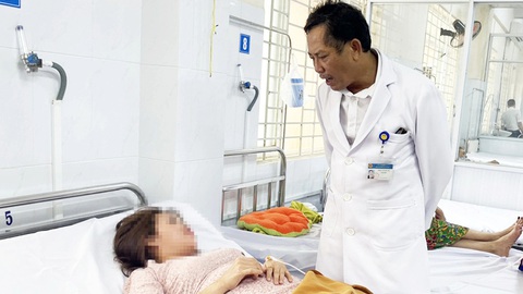 Mùa nắng nóng, kiểm soát thức ăn đường phố thế nào để ngăn ngộ độc thực phẩm?- Ảnh 1. Lãnh đạo Bệnh viện Đa khoa khu vực Long Khánh (Đồng Nai) thăm hỏi một bệnh nhân ngộ độc sau ăn bánh mì - Ảnh: A.B.