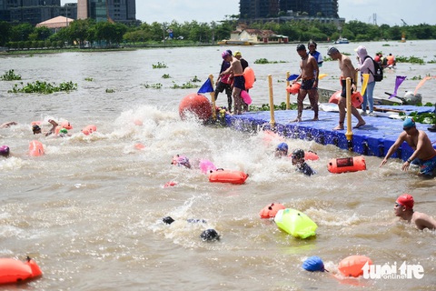 Lễ hội sông nước: Thi bơi, chèo ván đứng sôi nổi trên sông Sài Gòn- Ảnh 6. Nước sông và có nhiều bèo không cản được thành tích nổi bật của các vận động viên - Ảnh: PHƯƠNG QUYÊN