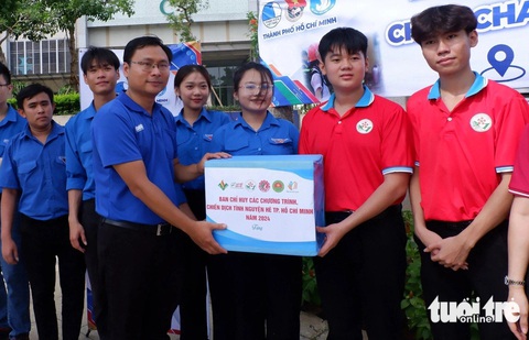 Thiếu nhi TP.HCM vui chơi, nhận quà trong ngày cao điểm vì đàn em- Ảnh 8. Phó bí thư Thành Đoàn TP.HCM Trương Minh Tước Nguyên trao quà đến đội hình chiến sĩ Hoa phượng đỏ tham gia thực hiện đường cờ Tổ quốc tại Thủ Đức sau lễ ra quân các chương trình, chiến dịch tình nguyện hè năm 2024 - Ảnh: K.ANH
