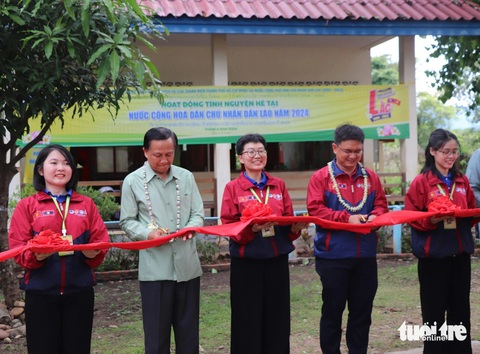 Chiến sĩ tình nguyện hè TP.HCM vẽ phòng học, làm sân chơi cho trẻ em Lào- Ảnh 3. Cắt băng khánh thành công trình sơn vẽ phòng học và sân chơi trong nhà dành cho thiếu nhi tại Trường tiểu học Kilomet số 3 - Ảnh: DIỆU QUÍ
