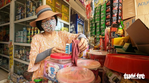 Nhà mặt tiền mà bạc mặt vì bụi bẩn thi công đường chậm chạp- Ảnh 3. Bà Nguyễn Thị Thanh Phúc (sống trên đường Bùi Thị Xuân) than trời vì tìm đủ mọi cách nhưng bụi bẩn vẫn ập vào nhà của bà, ảnh hưởng đến việc kinh doanh buôn bán - Ảnh: NHẬT LINH