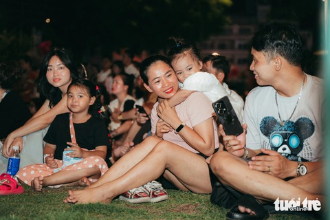 Người dân chen kín bờ sông Sài Gòn ngắm 1.100 drone thắp sáng bầu trời- Ảnh 3. Công viên bến Bạch Đằng trở thành khán đài chính của đông đảo người dân đến xem và hòa cùng các bản nhạc, ánh sáng sắc màu - Ảnh: THANH HIỆP