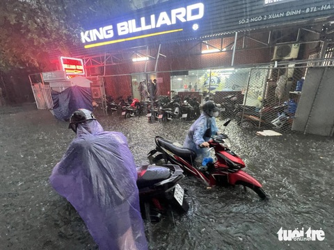 Mưa lớn, nhiều đường phố Hà Nội ngập lút bánh xe- Ảnh 4. Hai chiếc xe chung “số phận” chết máy vì đường ngập sâu - Ảnh: PHẠM TUẤN