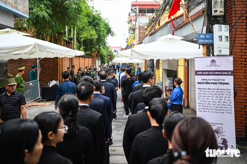Người dân nghẹn ngào tiễn biệt Tổng Bí thư Nguyễn Phú Trọng- Ảnh 4. Dọc hai bên đường từ trụ sở xã Đông Hội về làng Lại Đà, người dân đều treo cờ rủ để tưởng nhớ Tổng Bí thư