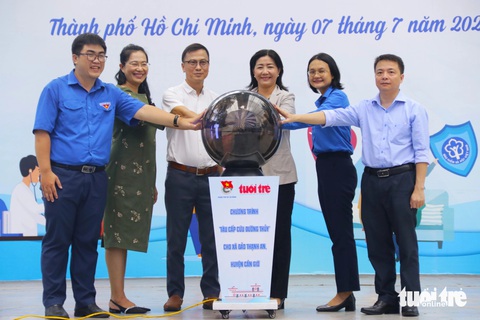 Phó bí thư Thành Đoàn TP.HCM: Hy vọng xã đảo Thạnh An sẽ sớm có tàu cấp cứu hiện đại- Ảnh 1. Bà Trần Thu Hà - phó bí thư Thành Đoàn TP.HCM (thứ 2 từ phải qua) và ông Phan Văn Đắc - trưởng ban công tác xã hội báo Tuổi Trẻ (thứ 3 bên trái qua) cùng đại diện lãnh đạo quận 5 thực hiện nghi thức phát động quyên góp ủng hộ chương trình tàu cấp cứu đường thủy cho người dân xã đảo Thạnh An - Ảnh: TIẾN QUỐC