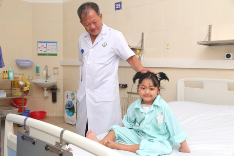Bé gái 7 tuổi được ghép tim, hồi sinh sự sống- Ảnh 1. Giám đốc Bệnh viện Hữu nghị Việt Đức Dương Đức Hùng chúc mừng bệnh nhi vừa được ghép tim - Ảnh: Bệnh viện cung cấp