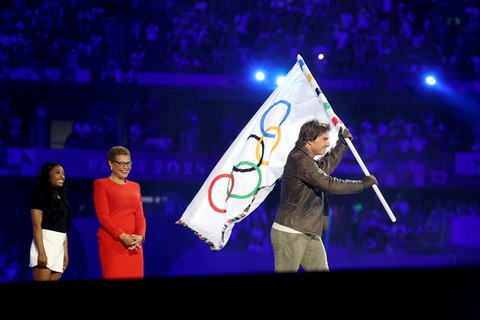 Tom Cruise đu dây như Mission: Impossible tại lễ bế mạc Olympic 2024- Ảnh 14. Tom Cruise nhận cờ từ thị trưởng Los Angeles, bà Karen Bass và nữ VĐV thể dục dụng cụ Simon Biles của Mỹ - Ảnh: REUTERS