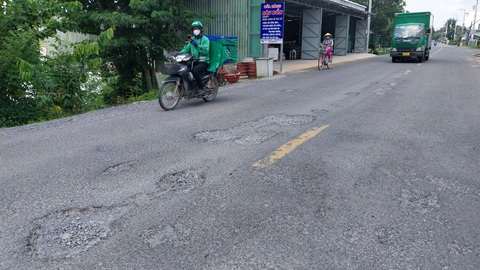 Con đường vừa sửa xong 8 tháng lại hư hỏng- Ảnh 1. Đường tỉnh 942 bị hư hỏng chỉ sau 8 tháng thi công, sửa chữa - Ảnh: CHÍ HẠNH