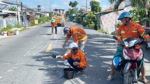 Con đường vừa sửa xong 8 tháng lại hư hỏng- Ảnh 3. Công nhân sửa chữa hư hỏng vào ngày 13-8 - Ảnh: CHÍ HẠNH