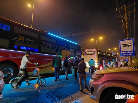 Xe dàn hàng ngang trên quốc lộ 1 đón khách, lực lượng chức năng nói 'xử lý không xuể'- Ảnh 9. Khu vực đối diện Khu chế xuất Linh Trung cũng xảy ra tình trạng xe khách chắn hết đường để trả khách lúc rạng sáng, ghi nhận vào ngày 1-8 - Ảnh: ĐÌNH KHẢI