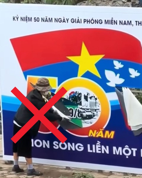Công an xác minh người phụ nữ ở Hà Nội cầm dao rạch biển pa nô chào mừng ngày thống nhất đất nước - Ảnh 1.