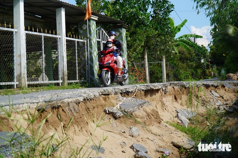 Đường dọc bờ sông sạt lở hơn một nửa, người dân vẫn bất chấp nguy hiểm để qua lại - Ảnh 2.