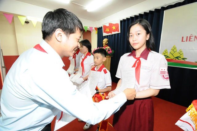 Anh Nguyễn Văn Tiệp (chủ tịch Hội đồng đội quận Tân Phú) trao quyết định thành lập cho ban chỉ huy liên đội lâm thời. - Ảnh: NGUYỄN HƯNG