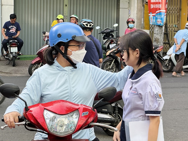 Sỹ tử tham gia kỳ thi tuyển sinh lớp 10 tại TP.HCM được bố mẹ khích lệ tinh thần bằng những cử chỉ tình cảm - Ảnh: MAI TRÚC