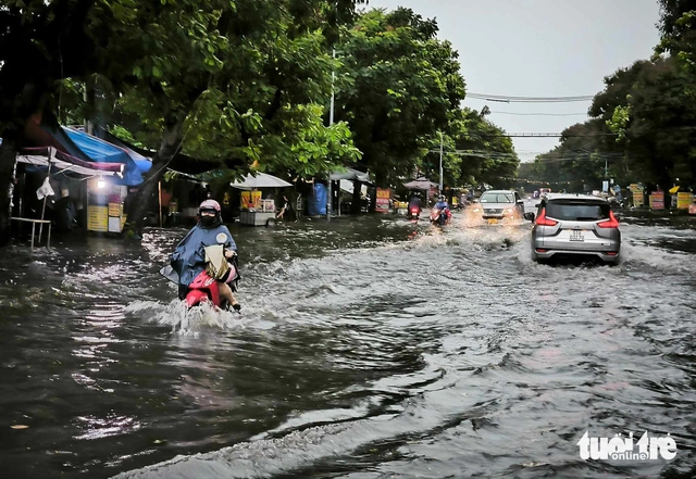 Heavy rains flood Ho Chi Minh City streets, dislodge drains, disrupt traffic - Ảnh 7. Heavy rains flood Ho Chi Minh City streets, dislodge drains, disrupt traffic - Ảnh 7.
