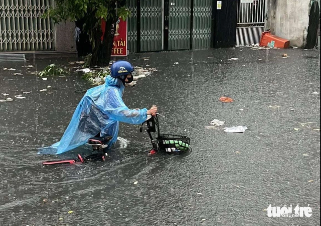 Heavy rains flood Ho Chi Minh City streets, dislodge drains, disrupt traffic - Ảnh 12. Heavy rains flood Ho Chi Minh City streets, dislodge drains, disrupt traffic - Ảnh 12.