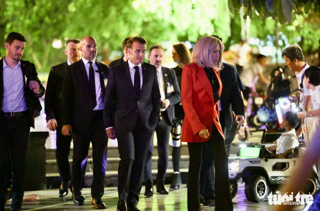 French president, his spouse stroll around Hoan Kiem Lake in Hanoi  - Ảnh 4.