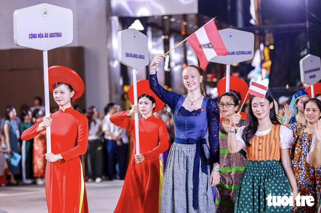 Vietnamese, foreigners in traditional costumes bring Hanoi streets to life- Ảnh 2.