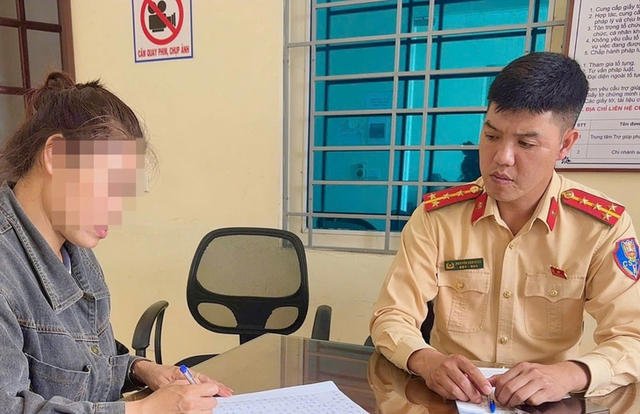 Woman summoned for letting child sit at steering wheel of moving car in Hanoi- Ảnh 1.