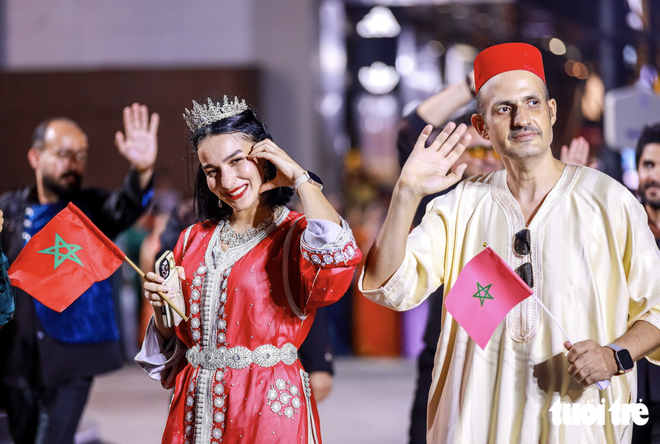 Vietnamese, foreigners in traditional costumes bring Hanoi streets to life- Ảnh 6.