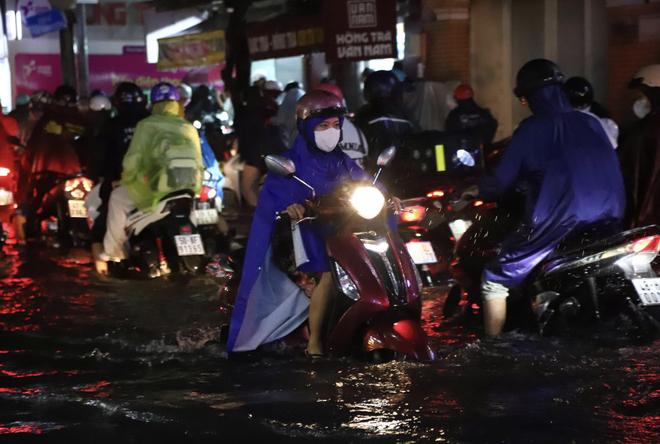 Downpours during rush hour causes severe flooding, traffic jams in Ho Chi Minh City - Ảnh 10.