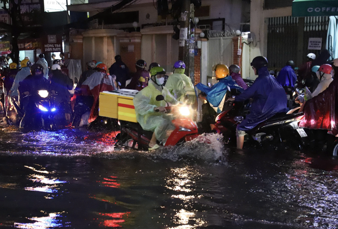 Downpours during rush hour causes severe flooding, traffic jams in Ho Chi Minh City - Ảnh 11.