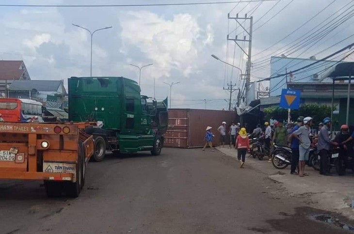 Thùng container rơi đè 2 vợ chồng trên quốc lộ 13 - Ảnh 1.