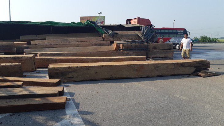 Xe chở gỗ lật giữa đường, nhiều người hú vía - Ảnh 2. Xe chở gỗ lật giữa đường, nhiều người hú vía - Ảnh 2.