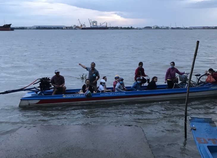 Công nhân chèo xuồng băng sông Hậu đi làm - Ảnh 1. Công nhân chèo xuồng băng sông Hậu đi làm - Ảnh 1.