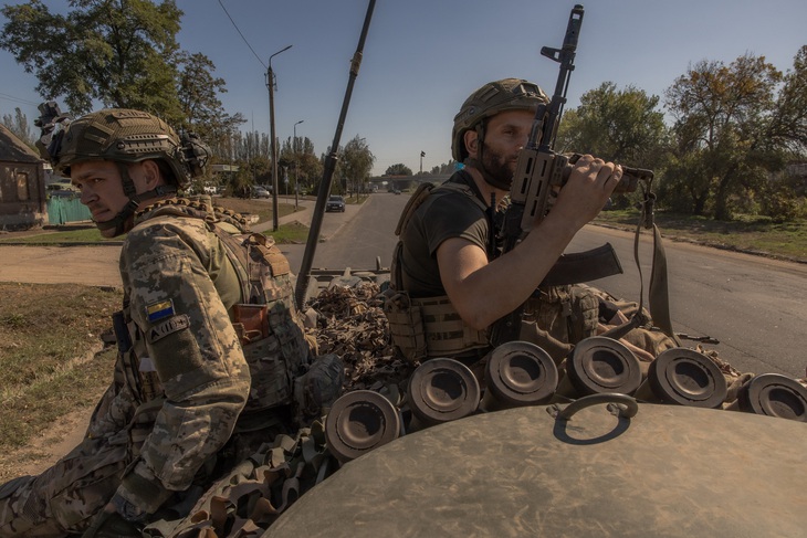 Các binh sĩ Ukraine ngồi trên xe quân sự tham gia chiến đấu ở vùng Donetsk - Ảnh: AFP