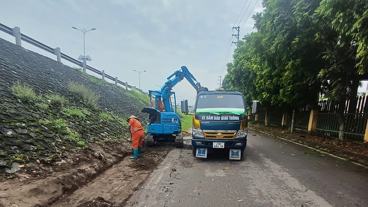 Công nhân và máy móc tham gia bảo dưỡng thường xuyên trên quốc lộ 2