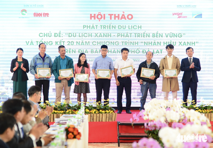 Ông Trần Xuân Toàn (phó tổng biên tập báo Tuổi Trẻ - bìa phải) và bà Trần Thị Vũ Loan (phó chủ tịch UBND TP Đà Lạt - bìa trái) trao giải cho các tác giả đoạt giải khuyến khích cuộc thi &quot;Hiến kế phát triển du lịch Đà Lạt bền vững&quot; - Ảnh: QUANG ĐỊNH