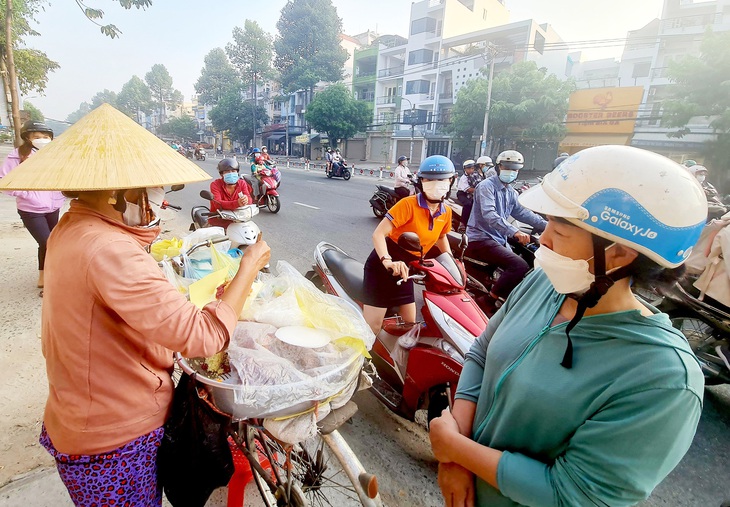 Chị Mến bán xôi tới 8 giờ sáng, nếu còn sẽ tiếp tục đi  bán dạo - Ảnh: MẠNH DŨNG