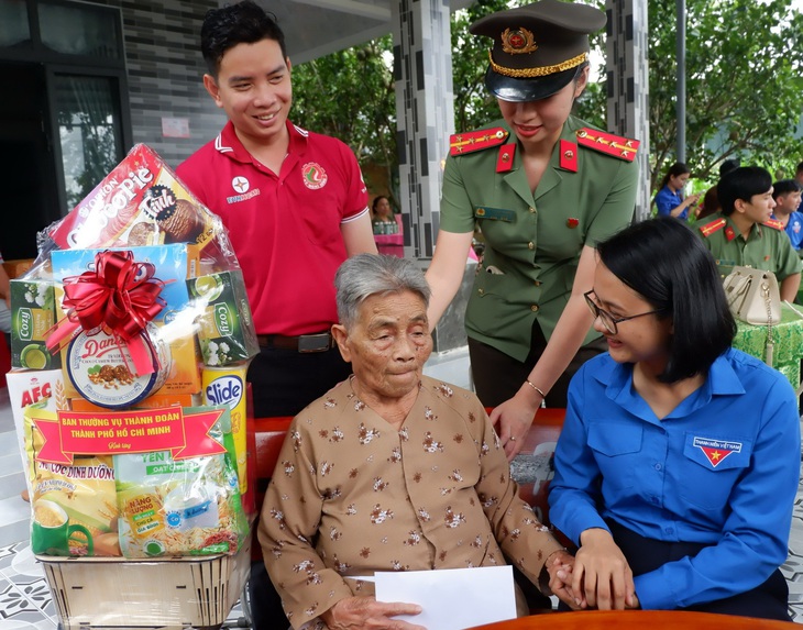 Phó bí thư Thành đoàn TP.HCM Trần Thu Hà trò chuyện, tặng quà Mẹ Việt Nam anh hùng Nguyễn Thị Bún (xã An Nhơn Tây, huyện Củ Chi, TP.HCM) - Ảnh: K.ANH