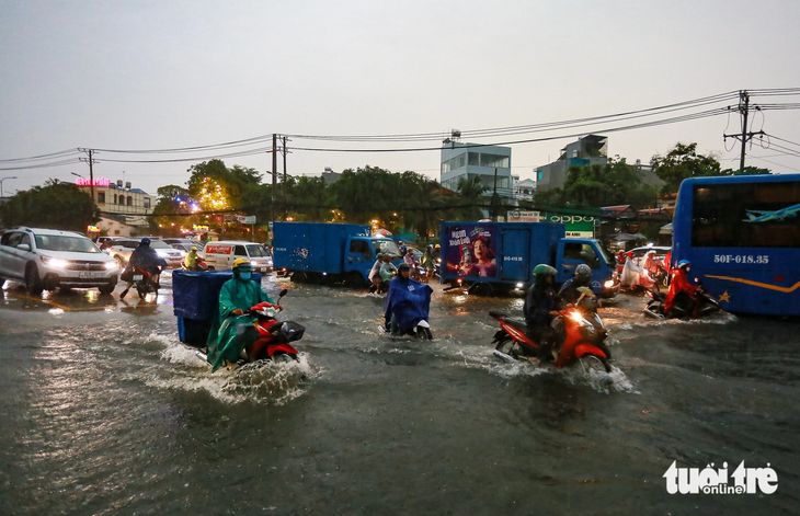 Anh Đinh Thanh Hùng - người bán quán cơm trên đường - cho biết quốc lộ 13 nắng thì bụi bặm, mưa thì ngập. Nhiều xe bị ngập chết máy dẫn bộ lội nước, số khác thì chạy lên vỉa hè vì sợ sóng nước xô ngã. &quot;Hàng quán xung quanh cũng khổ theo, chúng tôi nghe dự án mở rộng đường hơn 20 năm rồi nhưng chưa thấy làm&quot;, anh Hùng nói.